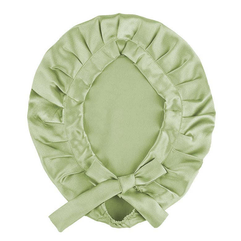 Light green silk bonnet with a bow on a white background